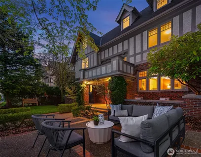 a backyard of a house with fountain table and chairs