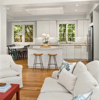 a living room with furniture and large windows