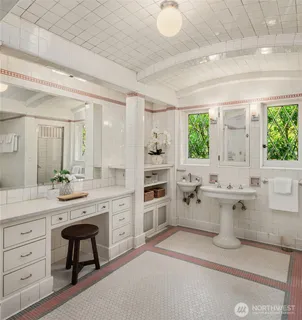 a spacious bathroom with a granite countertop sink mirror and a bathtub