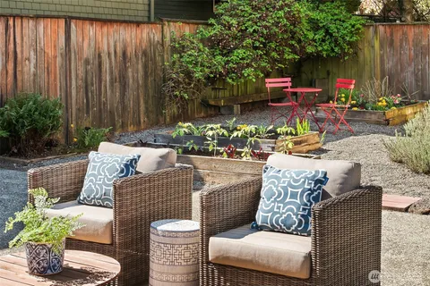 a view of a white building among the street with seating space