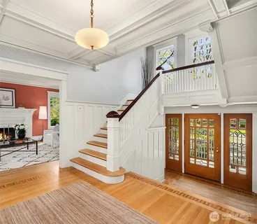 a view of entryway and hall with wooden floor