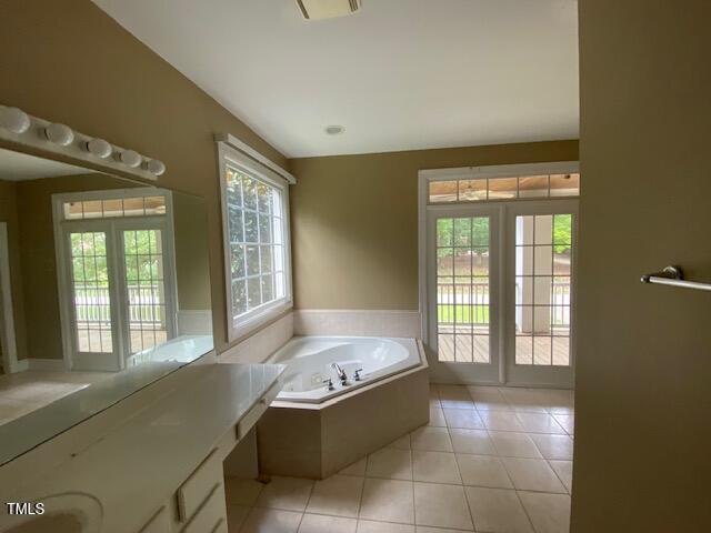 10912 Cahill Road Raleigh, NC 27614 - Photo 36 of 61 a large en suite bathroom with a tub sink and mirror
