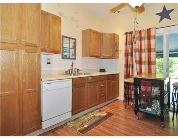 982 Crandall Road Tiverton, RI 02878 - Photo 3 of 10 a kitchen with a cabinets and chairs in it