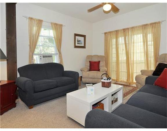 982 Crandall Road Tiverton, RI 02878 - Photo 7 of 10 a living room with furniture and large windows