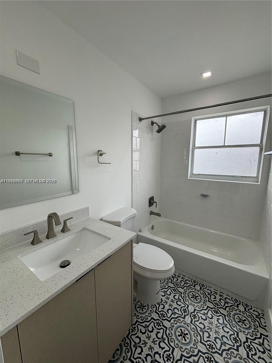 12637 Southwest 54th Street Miramar, FL 33027 - Photo 12 of 16 a bathroom with a sink toilet a mirror and shower
