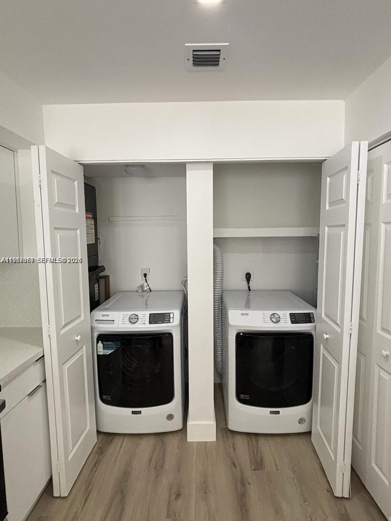 12637 Southwest 54th Street Miramar, FL 33027 - Photo 13 of 16 a utility room with stainless steel appliances a stove a microwave and sink