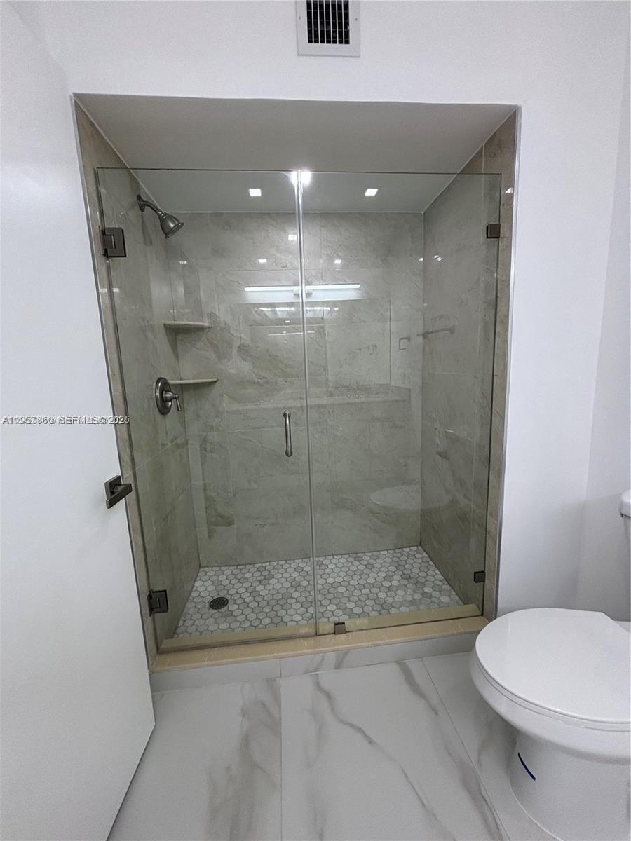 12637 Southwest 54th Street Miramar, FL 33027 - Photo 8 of 16 a bathroom with a shower and a toilet