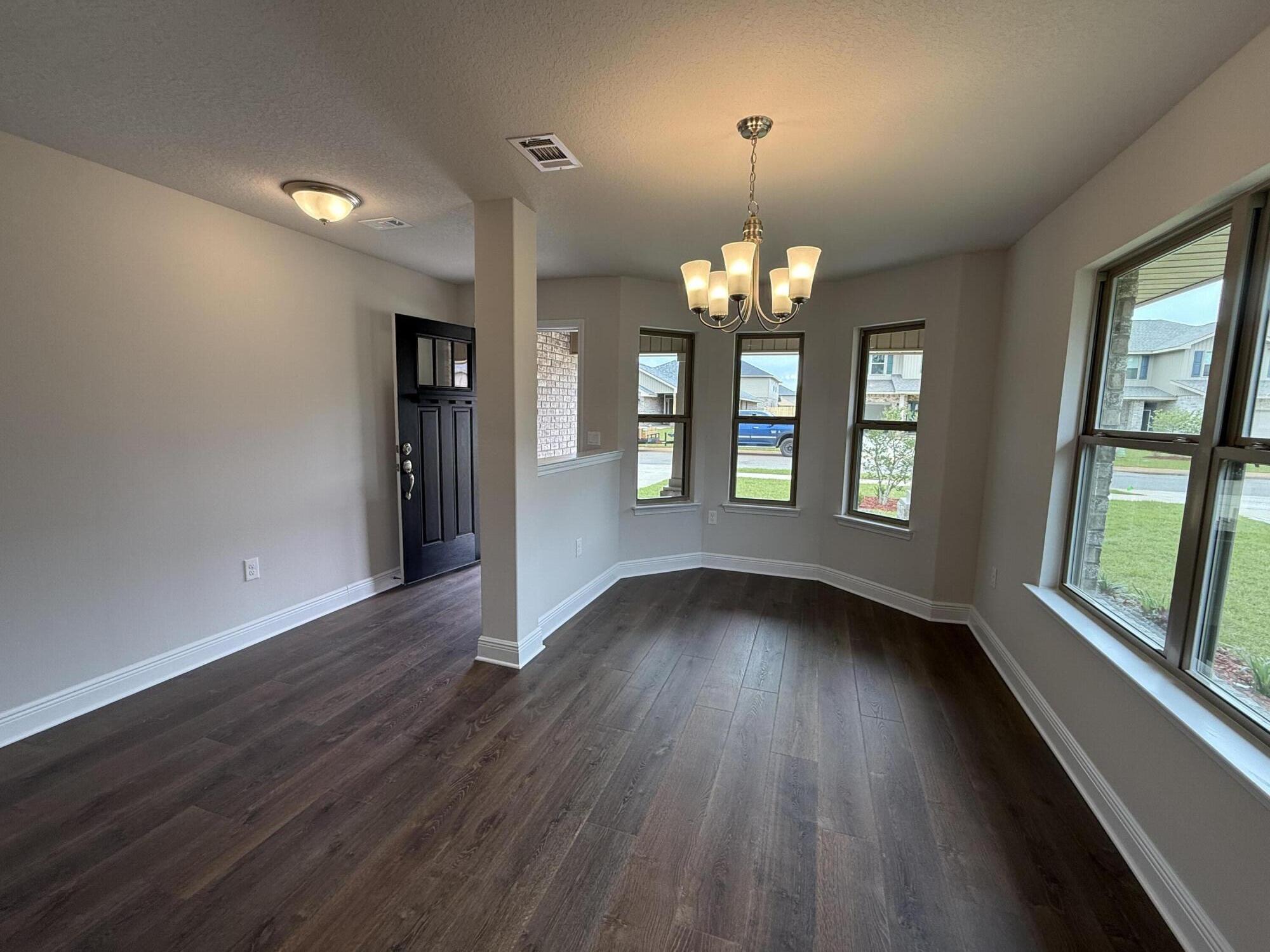 192 Ridgeway Circle Crestview, FL 32536 - Photo 6 of 18 wooden floor in an empty room with a window
