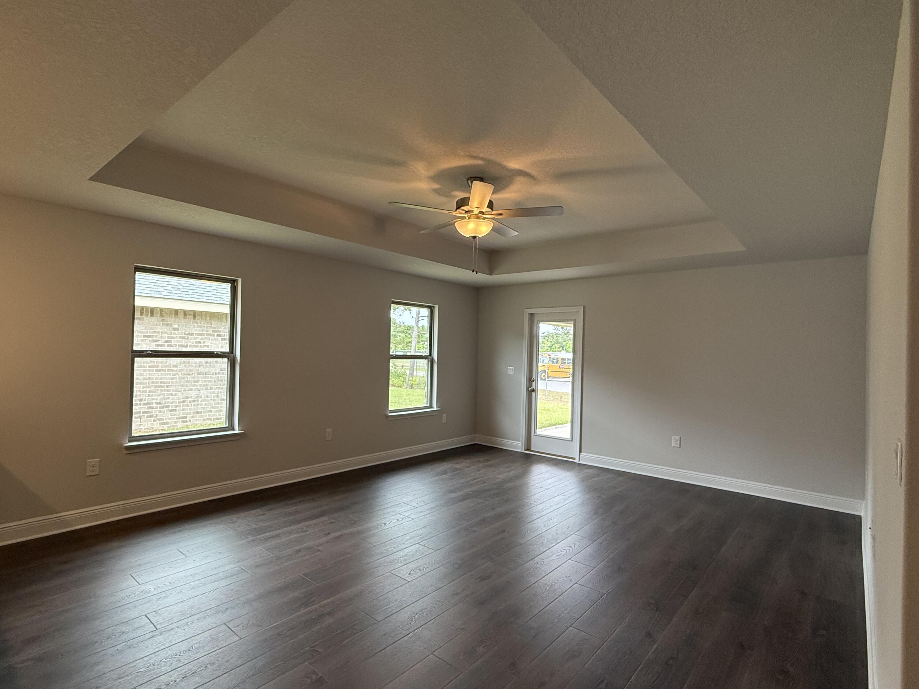 192 Ridgeway Circle Crestview, FL 32536 - Photo 9 of 18 an empty room with wooden floor and windows