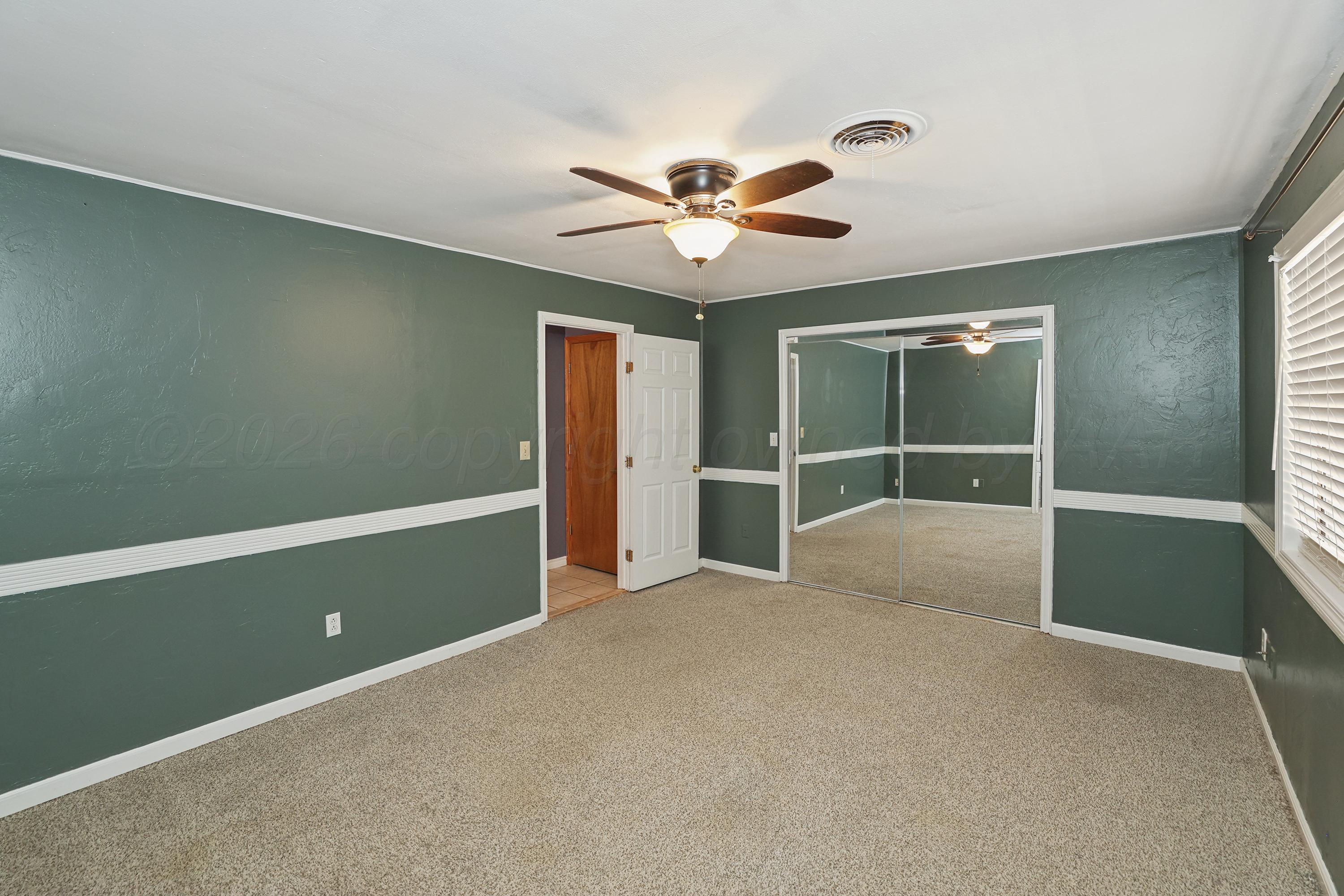 14200 Savannah Road Amarillo, TX 79118 - Photo 13 of 34 a view of an empty room with a ceiling fan