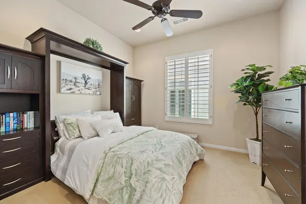 a bedroom with a bed and a painting on the wall