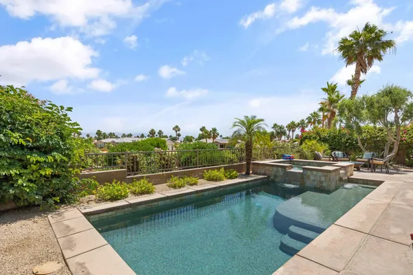 a view of a house with swimming pool and sitting area