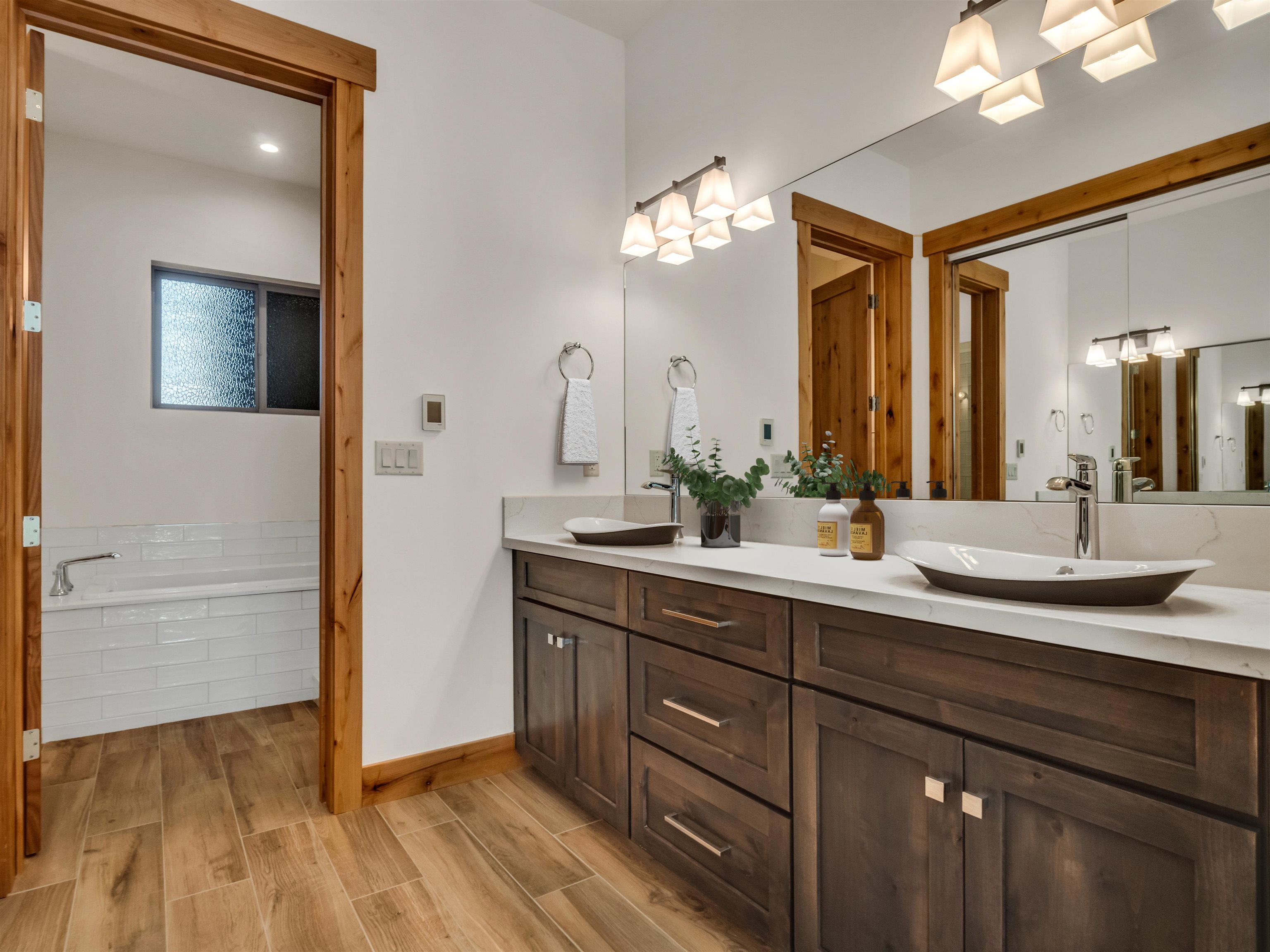 11643 McClintock Loop, Unit 3 Truckee, CA 96161 - Photo 5 of 21 a spacious bathroom with a double vanity sink and a mirror