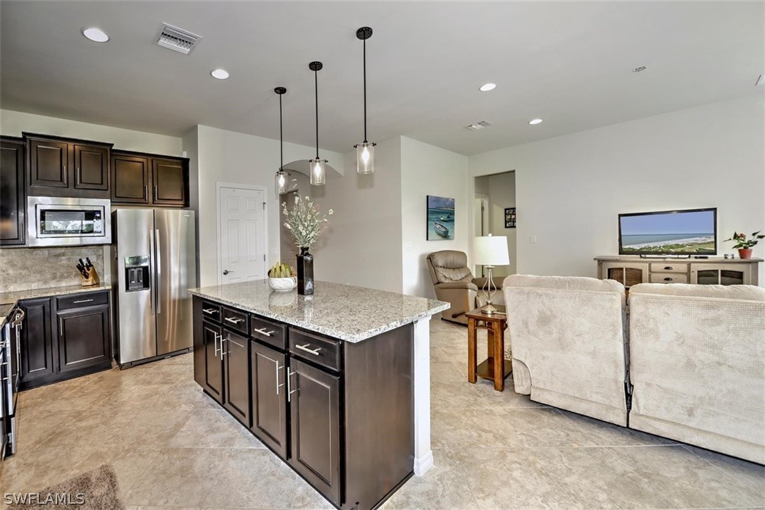 10928 Dennington Road Fort Myers, FL 33913 - Photo 12 of 35 a kitchen with stainless steel appliances granite countertop a sink a stove and a refrigerator