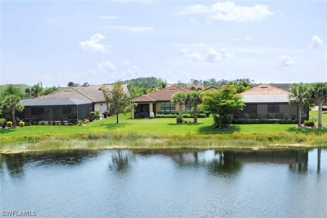 10928 Dennington Road Fort Myers, FL 33913 - Photo 27 of 35 a view of house with swimming pool and a yard