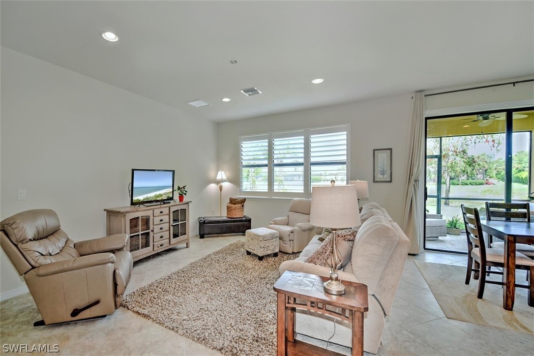 10928 Dennington Road Fort Myers, FL 33913 - Photo 7 of 35 a living room with furniture a flat screen tv and a large window