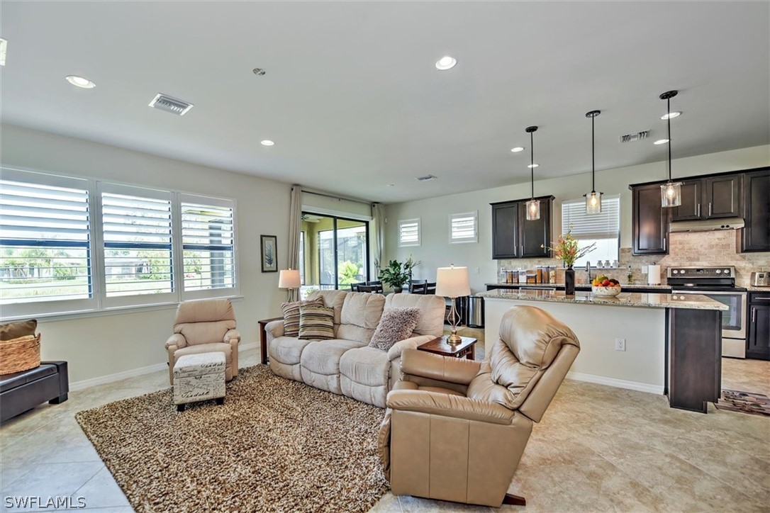 10928 Dennington Road Fort Myers, FL 33913 - Photo 8 of 35 a living room with furniture and kitchen view