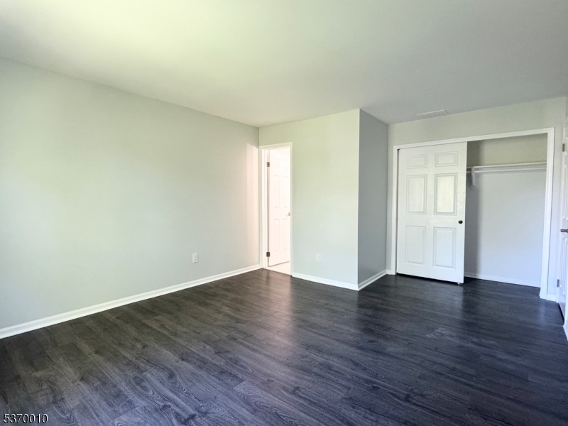 76 Jamestown Road Bernards, NJ 07920 - Photo 10 of 20 a view of an empty room with wooden floor and closet