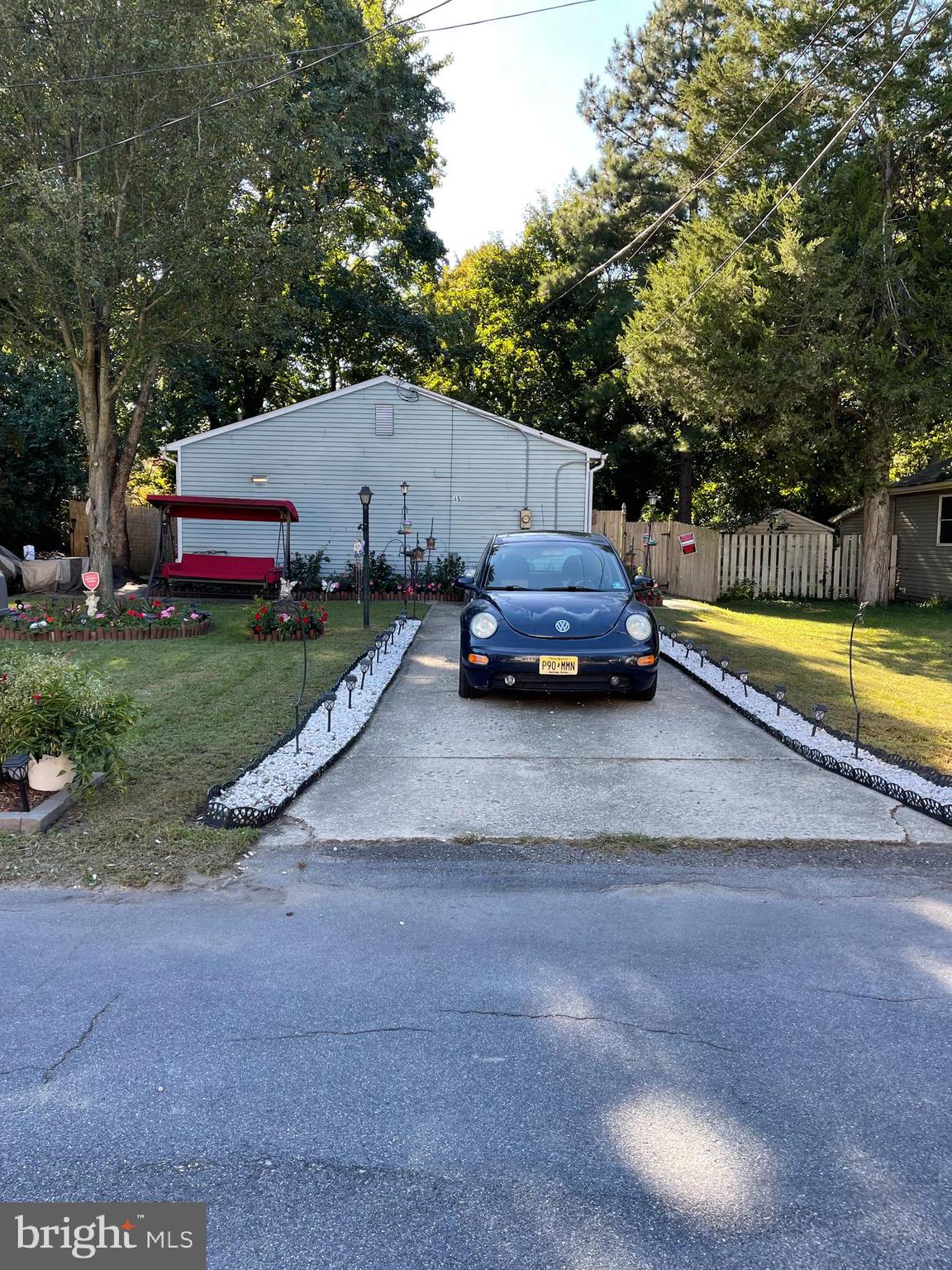 a car parked in front of a house with a small yard