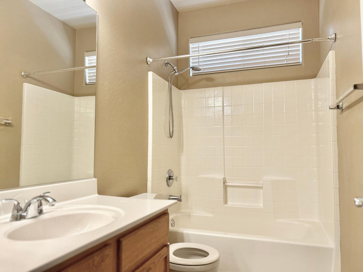6660 East Roland Street Mesa, AZ 85215 - Photo 14 of 17 a bathroom with a sink a mirror and a bathtub
