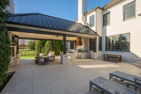 a living room with patio furniture and a fireplace