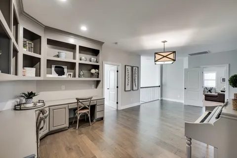 a kitchen with stainless steel appliances granite countertop a stove and a wooden floors