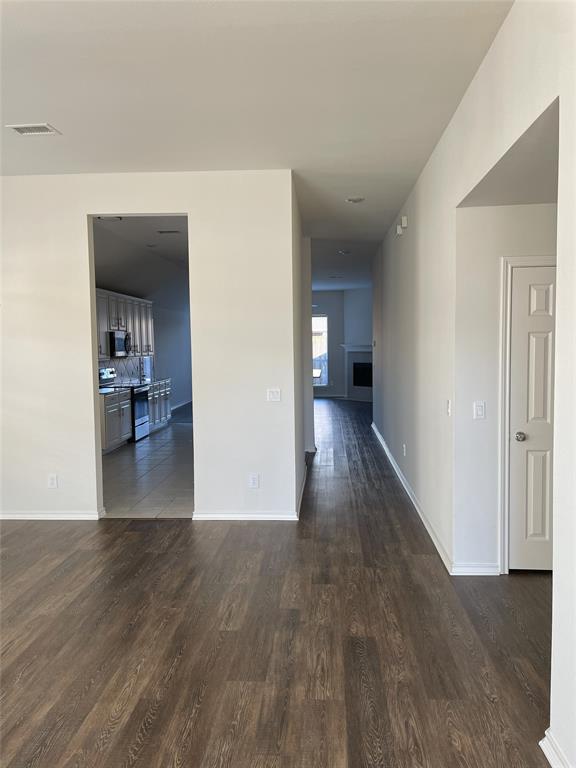 1133 Elm Grove Drive Allen, TX 75002 - Photo 2 of 11 Hall with dark wood finished floors and baseboards