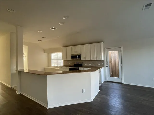 a kitchen with stainless steel appliances granite countertop a sink and cabinets