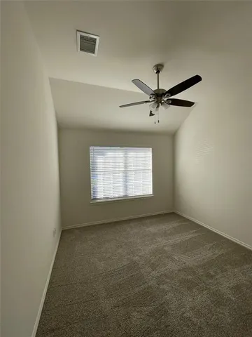 a view of room with a ceiling fan and window