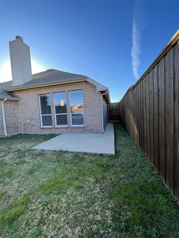 1133 Elm Grove Drive Allen, TX 75002 - Photo 10 of 11 Back of house with brick siding, a patio area, a fenced backyard, and a chimney