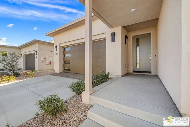 a view of a hallway with wooden floor and a bathroom