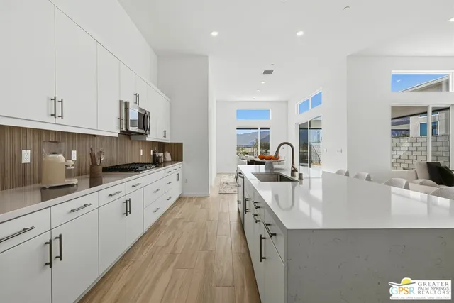 a view of a kitchen area with furniture and wooden floor