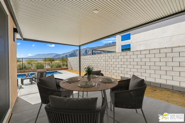 a view of a chairs and table in the patio