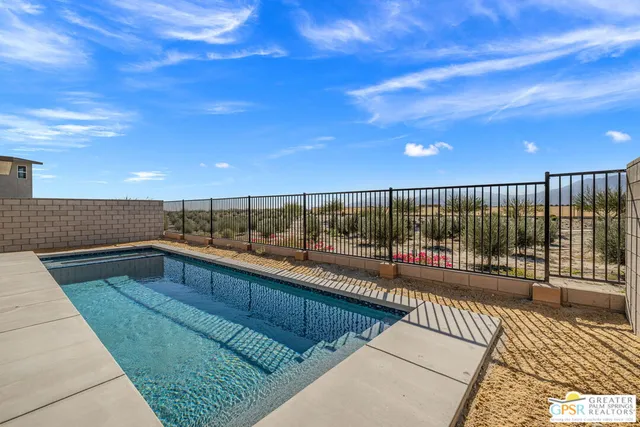 a view of a patio with couches and table with wooden floor