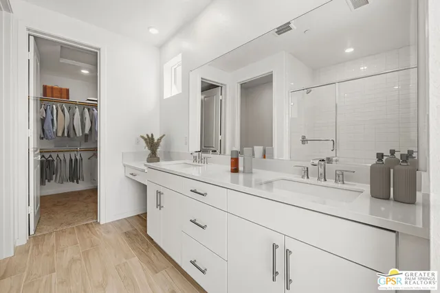 a view of walk in closet with clothes