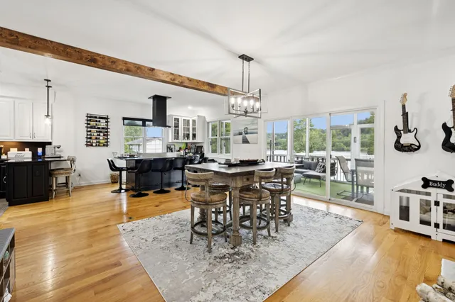 a kitchen with a dining table chairs and window