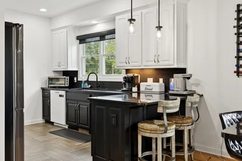 a kitchen with stainless steel appliances granite countertop a refrigerator and a stove