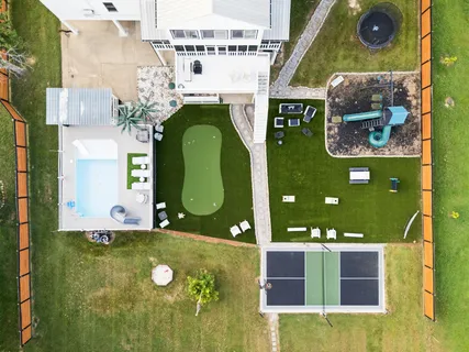 an aerial view of a house with outdoor space