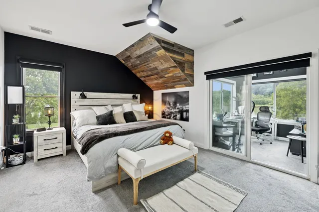 a view of a livingroom with furniture and floor to ceiling windows