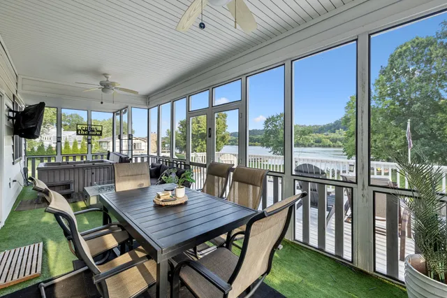 a view of a balcony with wooden floor and outdoor seating