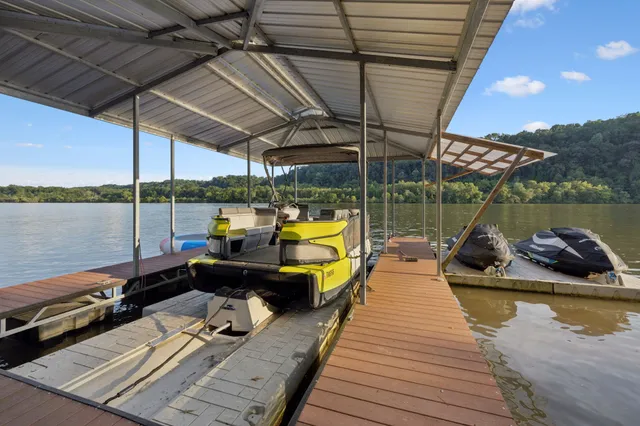 a view of a big house with a big yard and large trees