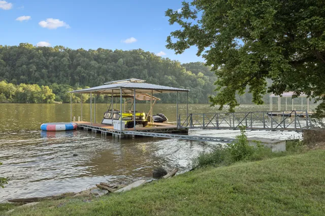 a view of a lake with house swimming pool and outdoor space