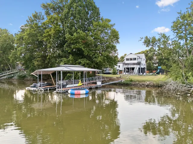 a view of a house with pool and a yard