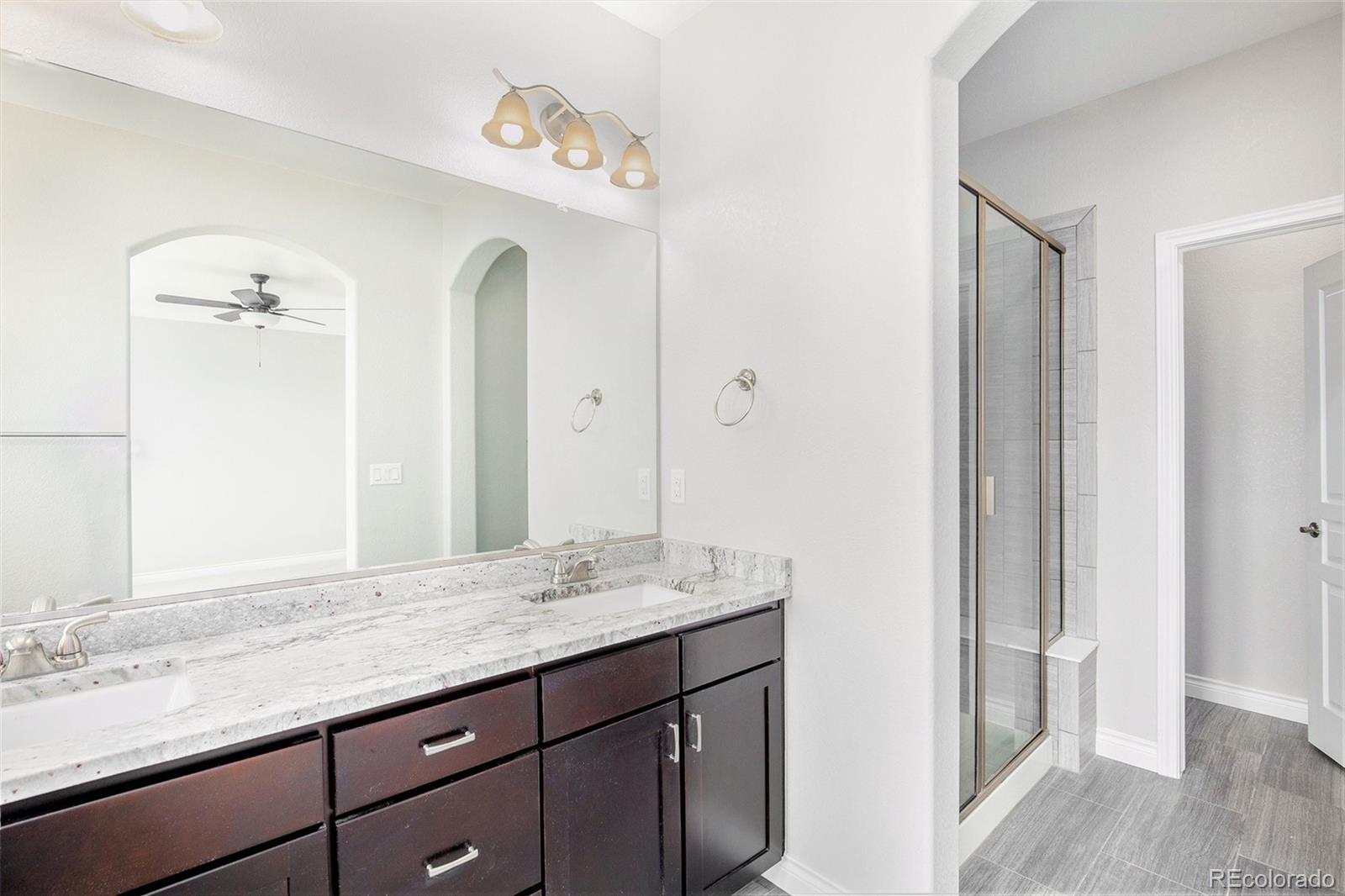 3751 West 136th Avenue, Unit C3 Broomfield, CO 80023 - Photo 14 of 20 a bathroom with a granite countertop sink and a mirror