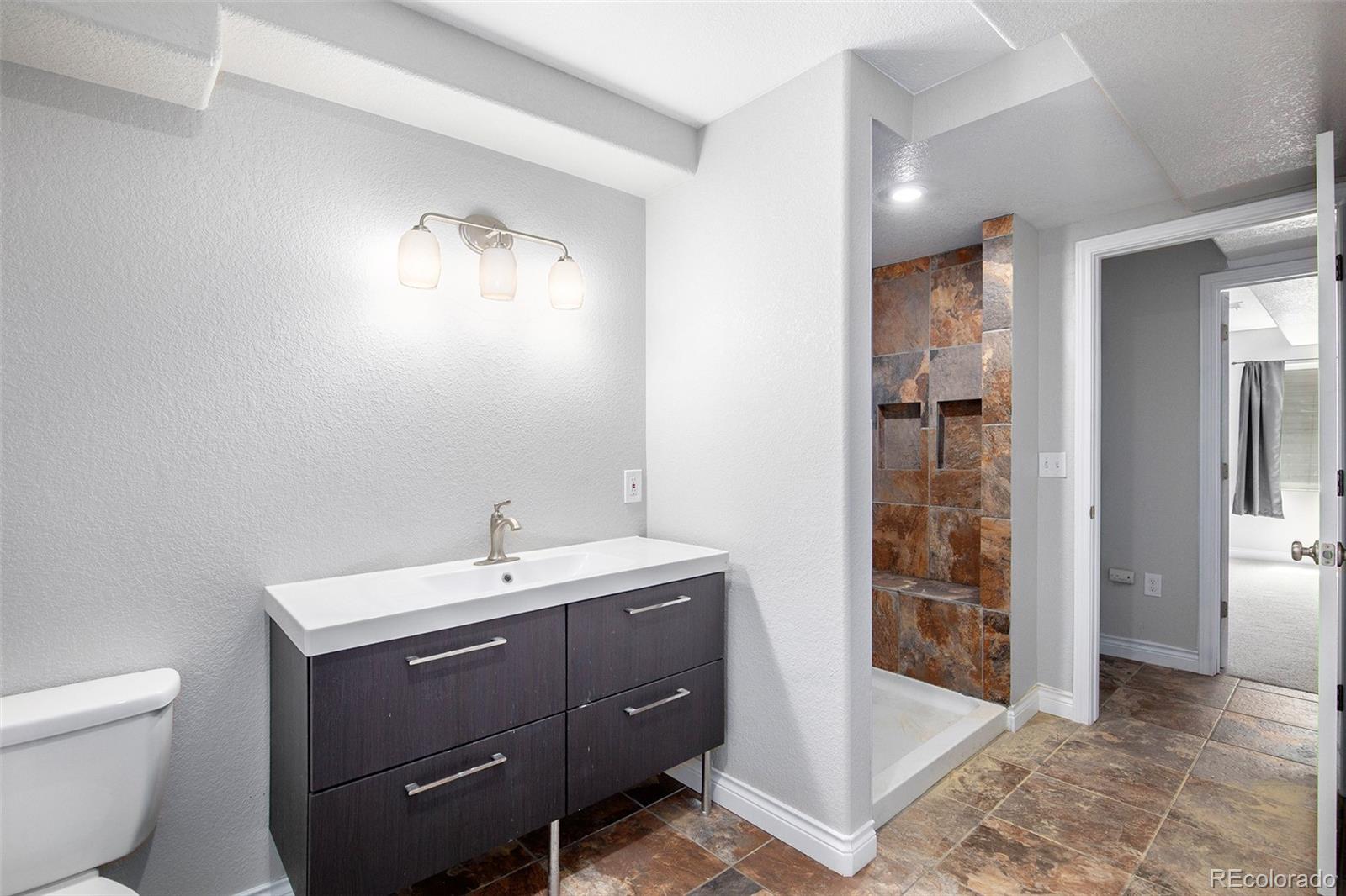 3751 West 136th Avenue, Unit C3 Broomfield, CO 80023 - Photo 18 of 20 a bathroom with a toilet sink and shower