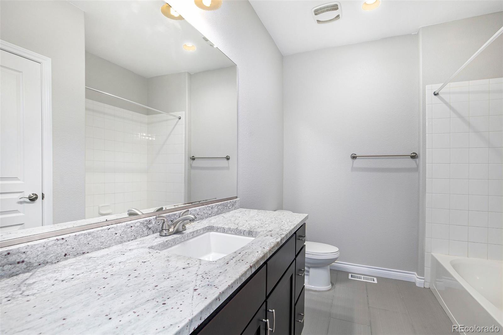 3751 West 136th Avenue, Unit C3 Broomfield, CO 80023 - Photo 20 of 20 a bathroom with a granite countertop sink toilet and shower