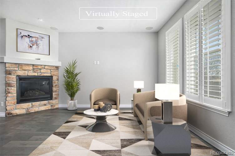 3751 West 136th Avenue, Unit C3 Broomfield, CO 80023 - Photo 2 of 20 a living room with furniture a window and a fireplace