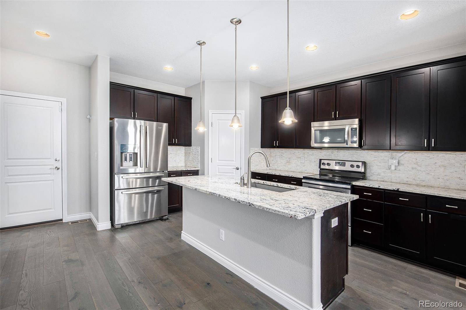 3751 West 136th Avenue, Unit C3 Broomfield, CO 80023 - Photo 4 of 20 a kitchen with stainless steel appliances granite countertop a sink a stove and refrigerator