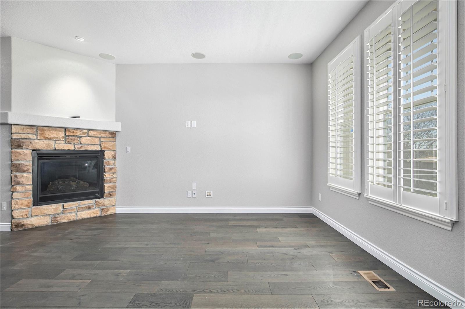 3751 West 136th Avenue, Unit C3 Broomfield, CO 80023 - Photo 5 of 20 a view of an empty room with a fireplace and a window