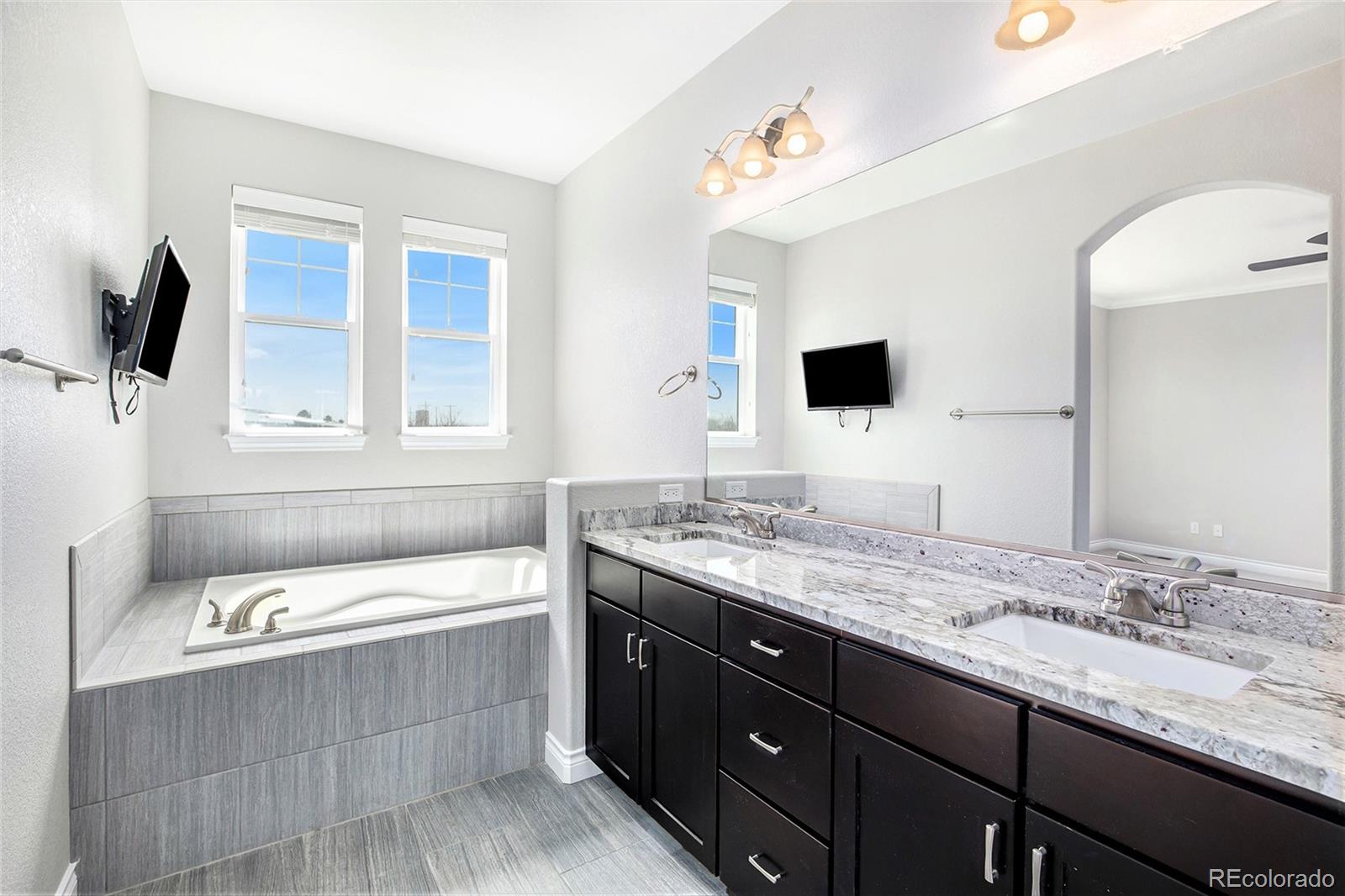 3751 West 136th Avenue, Unit C3 Broomfield, CO 80023 - Photo 6 of 20 a bathroom with a tub sink and mirror